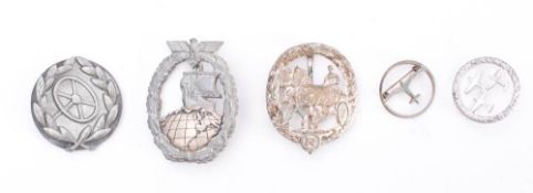 A collection of assorted original and replica Third Reich badges: includes, Horse Driver's Badge,