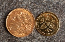 A 1906 Edward VII half sovereign with 9ct gold Princess Charlotte medallion.