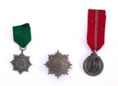 A WWII German Eastern Front Medal: together with an Ostvolk Decoration for Merit and an Eastern