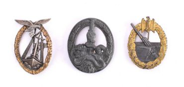 A reproduction German Anti Partisan Badge: together with a reproduction Naval Artillery badge and