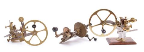 A 19th century lacquered brass watchmaker's mandrel: with 7 inch flywheel,