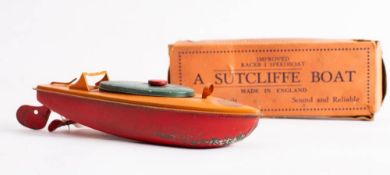 A Sutcliffe 'Improved Racer I Speedboat' tinplate clockwork boat: orange deck with green hatch