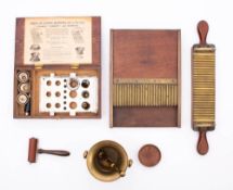 An early 20th century mahogany and brass apocathecary's pill sorter,