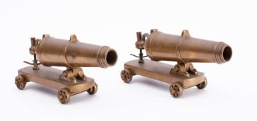A pair of 7 inch brass model cannonades on four wheeled brass carriages:.