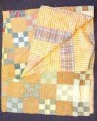 A mid 20th century patchwork quilt: of square geometric sections 232 x 214cm (some wear)