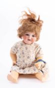 An early 20th century bisque head doll by Heubach Koppelsdorf: applied wig over blue glass