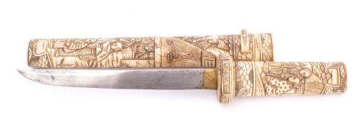 A 19th century tanto in carved bone scabbard: the short single edge blade with brass habaki over