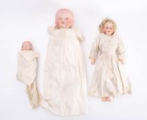 A late 19th /early 20th century continental bisque shoulder head doll: blonde wig,