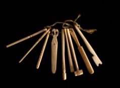 A set of nine 19th century bone teethers in the form of tools: including a fid, a hammer,