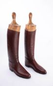 A pair of brown leather riding boots: (possibly a size 8),