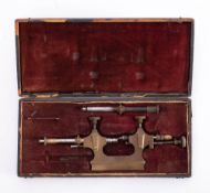 A vintage French watchmaker's brass Jacot tool: in a black leather covered fitted case inscribed