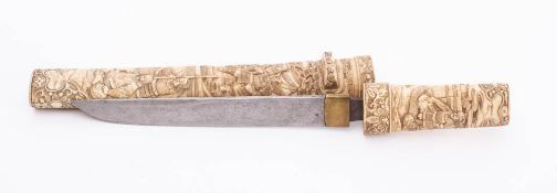 A 19th century tanto in carved bone scabbard: the short single edge blade with brass habaki over