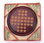 A late 19th/early 20th century boxed game of solitaire: the circular stained beech board with a