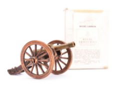 A group of various small model cannon: together with a piece of grape shot on a wooden plinth,