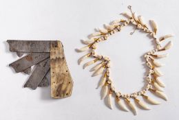 WITHDRAWN A Victorian yellow metal mounted otter tooth necklace: together with a memento mori
