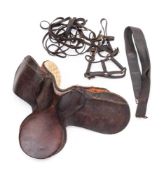 An early 20th century brown leather saddle: together with a collection of reins and tack.