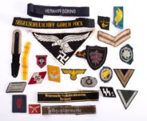 A group of German military cloth insignia: including cuff bands, a Luftwaffe Sports shirt eagle,