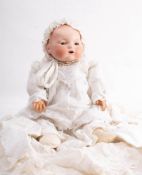 An Armand Marseille bisque head baby doll: moulded hair with sleeping eyes,