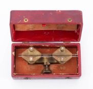 A vintage French watchmaker's brass depth tool: in red leather box inscribed 'Compass 26 Lignes'.