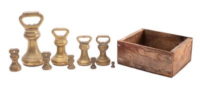 A graduated set of nine brass bell weights from 1/4 oz to 14lbs.