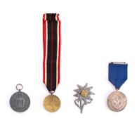 A WWII German War Merit Medal 1939: together with a Social Welfare Medal,