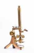 A lacquered brass microscope by J Swift,
