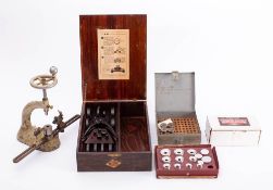 A collection of various watch and clock making tolls: including a watch crystal inserting machine