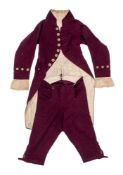 An early 19th century gentleman's purple wool long coat and matching breeches: with gilt brass