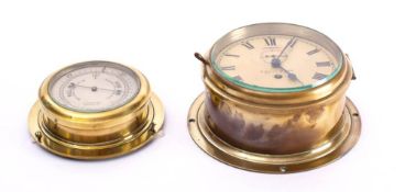 A circular brass bulkhead timepiece by F Smith & Son Southampton:,