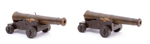 A pair of scale model cannon: the 8 1/2 inch barrels in naval 5/5 truck with large levered brass