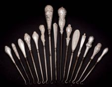 A collection of fifteen assorted silver-handled button hooks,