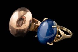 A synthetic star sapphire ring,: the oval cabochon synthetic star sapphire in a four claw setting,