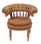 A Regency oak and button upholstered 'cockfighting' chair, circa 1815,