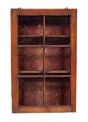 An oak and glazed wall cabinet, circa 1900,: of rectangular form, the hinged door with six panes,