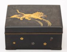 A Japanese komai-style gold and silver onlaid iron box: the hinged lid decorated with a lion and