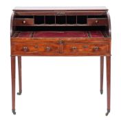 A late George III mahogany roll top desk, circa 1800,: the rectangular top above a tambour front,