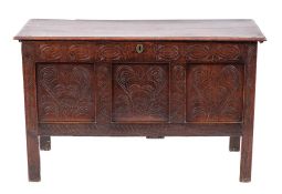 A carved oak coffer, late 17th century and later,
