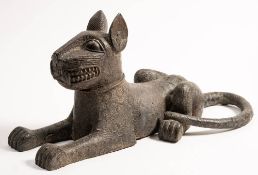 A Benin bronze statue of a recumbent leopard: with pricked ears and all over circular punched