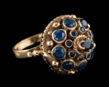 A sapphire dress ring,: set with a cluster of circular cut sapphires, stamped 18k, ring size K.