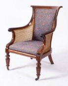 A Regency or George IV mahogany and canework library bergere, circa 1820,