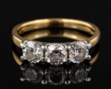 An 18 carat gold three stone diamond ring,: the three brilliant diamonds approximately 1.