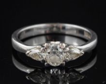 A diamond three stone ring,: the oval cut diamond estimated to weigh 0.