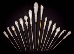 A collection of fifteen assorted silver-handled button hooks,
