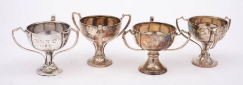 Four near matching triple handled trophy cups, maker Alexander Clark & Co Ltd, Birmingham,