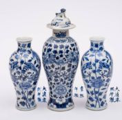 A pair of Chinese blue and white 'dragon' vases and one similar with cover: each painted with