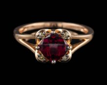 A garnet and diamond ring,: the cushion shaped garnets in a four claw setting,