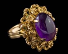 An amethyst dress ring,: the oval cabochon amethyst in a four claw setting,