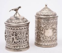 An Indian silver jar and cover: of cylindrical outline, with shallow domed lid with bird finial,