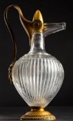 A 19th century clear glass and gilt metal mounted wine ewer and stopper: of baluster form,