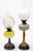 A late 19th century oil lamp: with pale blue glass reservoir on a reeded brass column on a domed
